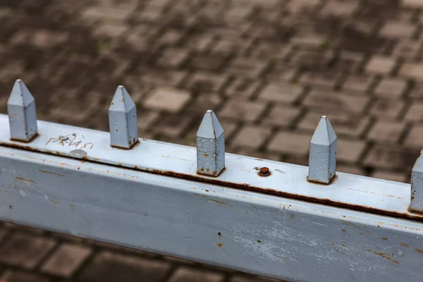 Studded fence of private area. Protective enclosure of specially protected object. Metal Protective fence with iron spikes. Symbol private property, metal barbed fence with spikes against vandals