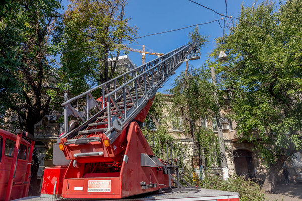 Odessa, Ukraine - October 14, 2015: Working chainsaw cut dry wood. Groundscare urban service eliminates emergency trees with the help of crane. Emergency Prevention