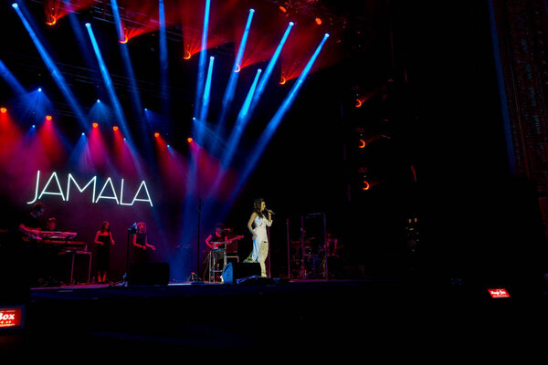 ODESSA, UKRAINE - July 16, 2016: Ukrainian singer Jamala at solo concert at Opera House. Delighted fans in hall. Jamal won 61st annual Eurovision Song Contest with song "1944" in Stockholm in 2016.