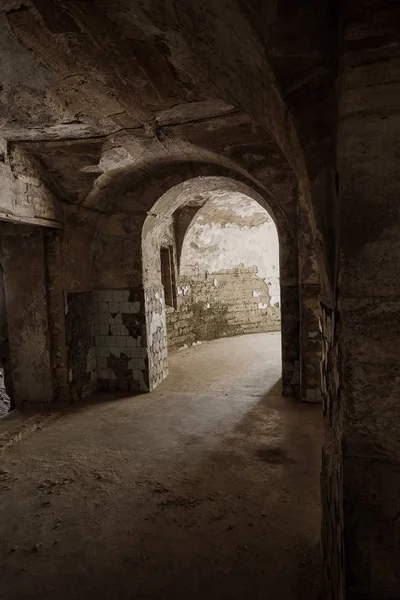 地下酒窖里的一条废弃的旧隧道 地下墓穴的入口 地牢老石头堡垒 作为举办黑暗设计的创意背景 古代地牢的神秘内部 — 图库照片