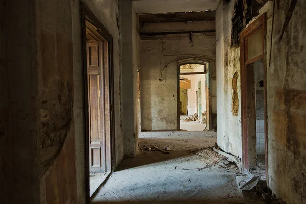 Mystical interior, ruins of an abandoned ruined building of an ancient 18th century building. Old ruined walls, corridor with garbage and mud. Destroyed molding, gypsum decorations, bas-relief