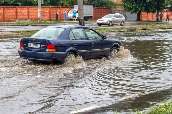 ODESSA, UKRAINE - July 24, 2014: As a result of heavy rainfall disaster flooded streets. Cars fording. Flooding. July 24, 2014 in Odessa, Ukraine