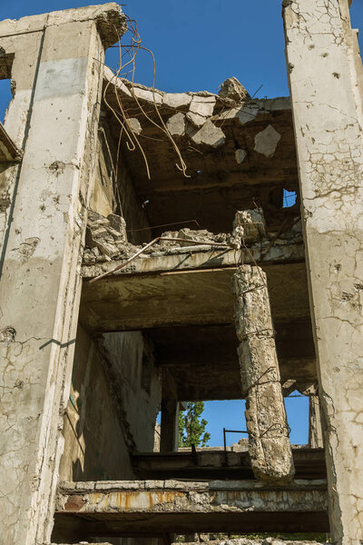 Abandoned destroyed by the explosion, bombing and shelling the destroyed building. Holes from shells, traces of bullets and splinters on the walls of a war-ravaged building. Old ruined house