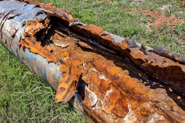 Eski büyük su boruları parçaları. Sonra uzun yıllar çalışma aşınmış metal boru yok. Paslı çelik boru delik metal korozyon ile. Seçici odak.
