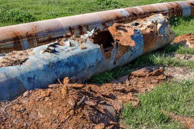 Eski büyük su boruları parçaları. Sonra uzun yıllar çalışma aşınmış metal boru yok. Paslı çelik boru delik metal korozyon ile. Seçici odak.