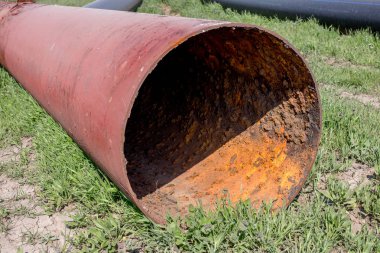 Eski büyük su boruları parçaları. Sonra uzun yıllar çalışma aşınmış metal boru yok. Paslı çelik boru delik metal korozyon ile. Seçici odak.