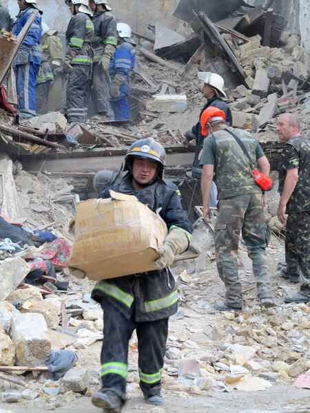 ODESSA, UKRAINE - MAY 23: Residential building destroyed during the earthquake. Rescuers and volunteers and military apart the rubble in search of the living, May 23, 2013 Odessa, Ukraine