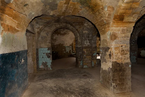 An old abandoned tunnel in an underground wine cellar. Entrance to catacombs. Dungeon Old stone fortress. As creative background for staging dark design. Mystical interior of ancient dungeon