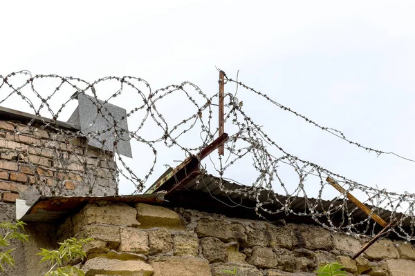 Barbed wire - Barbed wire razor fence on the walls of industrial plants