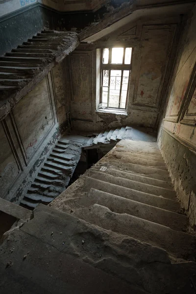 Mystical interior, ruins of an abandoned ruined building of an ancient 18th century building. Old ruined walls, corridor with garbage and mud. Destroyed molding, gypsum decorations, bas-relief