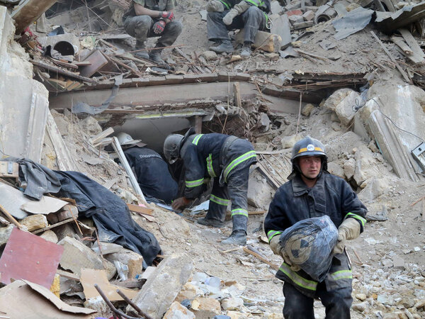 ODESSA, UKRAINE - MAY 23: Residential building destroyed during the earthquake. Rescuers and volunteers and military apart the rubble in search of the living, May 23, 2013 Odessa, Ukraine