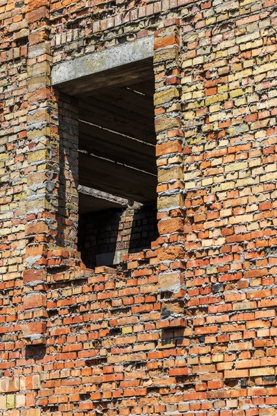 Ruined wall of building. Abandoned to unnecessary houses are destroyed. Self-destruction of abandoned buildings. Conceptually, crisis, migration, war. Brick house is destroyed. Window and wall are broken