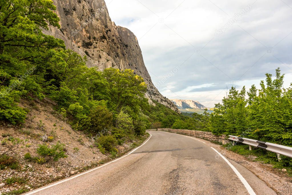 Good asphalted road along the picturesque rocky high mountains in Crimea.