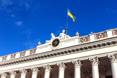 Cephe bina resmi Odessa City Hall ile şehrin ana saat ve Ukrayna bayrağı parlak mavi gökyüzü bir arka plan üzerinde