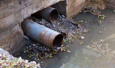 Eski beton ve paslı metal, demir döküm drenaj boruları ve şantiye topraklarında. Konsolide edilen Atıksu sistemi, yere fırlattı. Onarım drenaj çukuru yağmur suyu drenaj sistemi