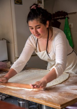 Sudak, Rusya Federasyonu - 15 Mayıs 2015: Genç güzel kız hamur rulo ve ulusal Kırım Tatar yemek pasties küçük bir mutfak, bir fast food restoran hazırlamak. Kırım - Tatar ulusal mutfağı