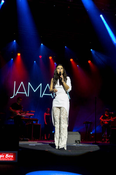 ODESSA, UKRAINE - July 16, 2016: Ukrainian singer Jamala at solo concert at Opera House. Delighted fans in hall. Jamal won 61st annual Eurovision Song Contest with song "1944" in Stockholm in 2016.