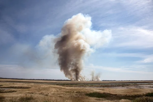 Strong prairie fire with large clouds of choking smoke erupted in southern steppe during the summer drought. The line of fire is coming to town houses. Ecological catastrophy