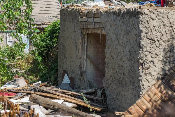 Ruined wall of building. Abandoned to unnecessary houses are destroyed. Self-destruction of abandoned buildings. Conceptually, crisis, migration, war. Brick house is destroyed. Window and wall are broken