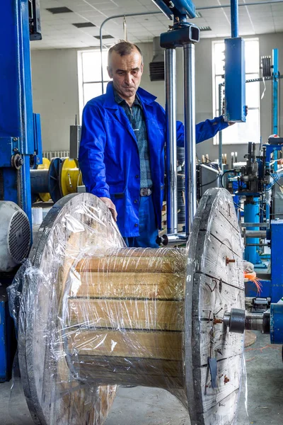 Fragment inside a modern plant producing power electric cables and optical fibers. Interior of modern production line technology obsolescence