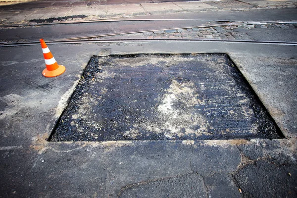 Odessa, Ukraine, August 16, 2015 - repair of asphalt road in the city center. hole in the asphalt in the parking of the carriageway. Job asphalt surfacing machiner