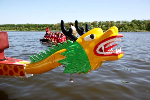 Odessa, Ukraine - May 16, 2010: Championship of Ukraine rowing among veterans. Dragon boat on the river. People rowing boat in the race in the summer