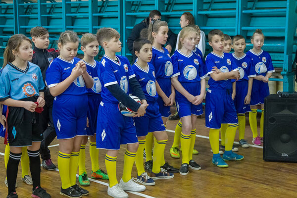 ODESSA, UKRAINE- Febr 24,2018: Young children play rugby during derby games of city school in closed hall. Children's sports. Children play in rugby 5. Fight for victory of children. Healthy lifestyle