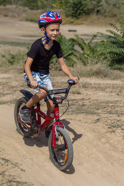 ODESSA, UKRAINE - August 2, 2018: Athletes on sports bicycles compete on mountainous terrain. Family sports leisure with children, healthy way of life, Cyclocross - day off sport in nature