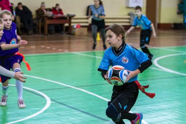 Odessa, Ukrayna - Hazi 24,2018: Küçük çocuklar kapalı salonunda şehir okulun derby Oyunlar sırasında rugby oynamak. Çocuk spor. Çocuk rugby 5 oyun. Çocuk zafer için mücadele. Sağlıklı yaşam tarzı