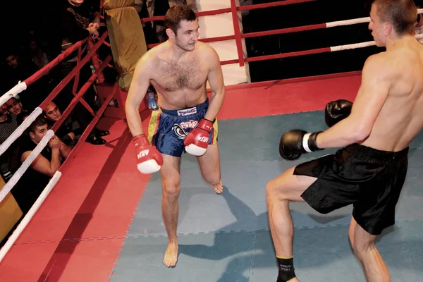 Odessa, Ukraine - October 14, 2010: Fight Club. Fighting without rules. Mixed martial arts fighters compete in the cell, resulting in punches and kicks. The dramatic moment of the battle.