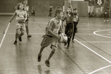 Odessa, Ukrayna - Hazi 24,2018: Küçük çocuklar kapalı salonunda şehir okulun derby Oyunlar sırasında rugby oynamak. Çocuk spor. Çocuk rugby 5 oyun. Çocuk zafer için mücadele. Sağlıklı yaşam tarzı