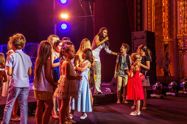 ODESSA, UKRAINE - July 16, 2016: Ukrainian singer Jamala at solo concert at  Opera House. Satisfied with  fans in hall. Spectators at  concert during  creative light and music show fashionable jazz orchestra