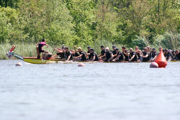 Odessa, Ukraine - May 16, 2010: Championship of Ukraine rowing among veterans. Dragon boat on the river. People rowing boat in the race in the summer