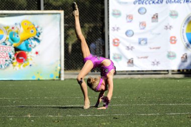 Odessa, Ukrayna - 2 Eylül 2015: Parlak dinamik özellikleri bir destek grubu Bayan spor takımı. Performans destek grubu. Parlak güzel genç kız spor dans formu parkta