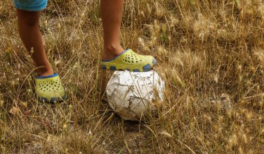 Eski yıpranmış eski püskü ve yırtık futbol topu kırsal alanında stadyumu terk edilmiş. Eski sildi su kuyusu-damat stadyum üzerinde ovuşturdu, yıpranmış, ile yırtık delik şımarık deri topu. Eski deri topun çimenlerin üzerinde