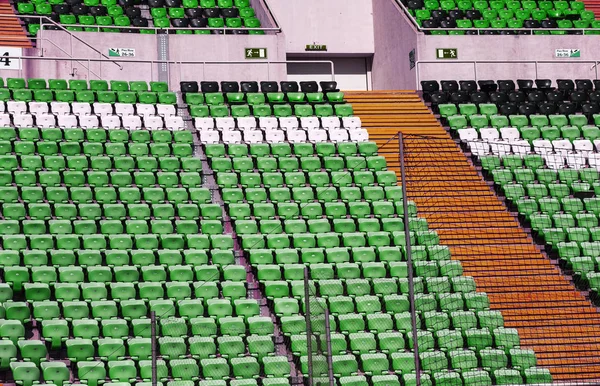 Empty old plastic chairs in the stands of the stadium. Many empty seats for spectators in the stands. Empty plastic chairs, seats for football fans. Tribune, game without spectators