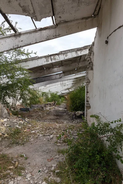 Interior of the destroyed buildings of old factory. ruins of an industrial enterprise, dark fragments destroyed factory premises at plant as result of economic crisis Catacombs, basement, tunnel