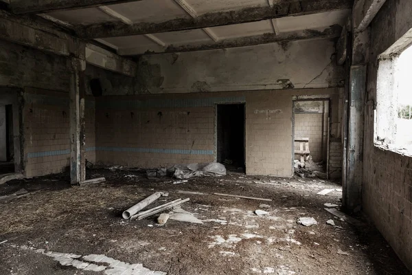 Interior of the destroyed buildings of old factory. ruins of an industrial enterprise, dark fragments destroyed factory premises at plant as result of economic crisis Catacombs, basement, tunnel