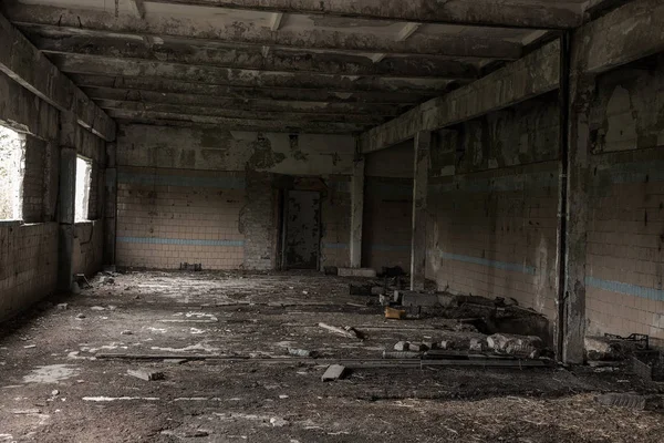 Interior of the destroyed buildings of old factory. ruins of an industrial enterprise, dark fragments destroyed factory premises at plant as result of economic crisis Catacombs, basement, tunnel