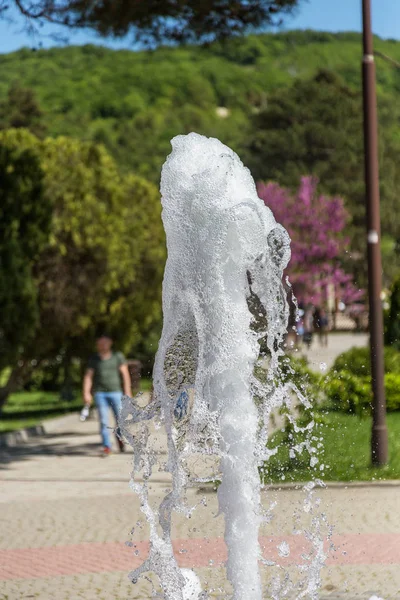 Flow of water of city fountain. Water splash, abstract image. Foam in jet of water. Flow of water fountain. Fragment of recreation zone of the city park of the southern city of Abrau-Durso, Russia