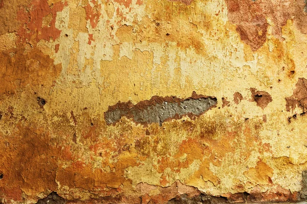 Empty old art texture of plaster brick wall. Painted bad scratched surface in fissures of painted stucco of stone brick wall with petal texture. rubbed facade of building with damaged plaster