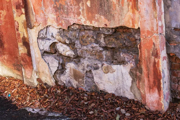 old art texture of plaster brick wall. Painted bad scratched surface in fissures of painted stucco of stone brick wall with petal texture. rubbed facade of building with damaged plaster background