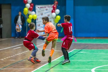 Odessa, Ukrayna - Decemb 25, 2018: genç çocuk oyun rugby şehir okul Derby kapalı odasında oynarken. Çocuk spor. Çocuk rugby 5 oyun. Çocuk zafer için mücadele. Sağlıklı yaşam tarzı