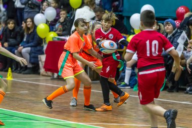 Odessa, Ukrayna - Decemb 25, 2018: genç çocuk oyun rugby şehir okul Derby kapalı odasında oynarken. Çocuk spor. Çocuk rugby 5 oyun. Çocuk zafer için mücadele. Sağlıklı yaşam tarzı