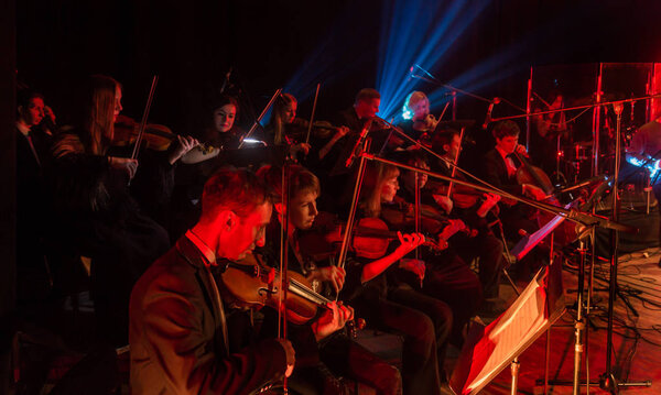 ODESSA, UKRAINE - JANUARY 24, 2019: Symphony orchestra concert on theater stage. Musicians of State Symphony Orchestra, instruments of symphony orchestra on stage. Score, sheet music during concert