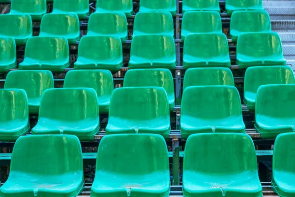 Empty old plastic chairs in the stands of the summer theater. Many empty seats for spectators in the stands of the amphitheater. Empty plastic chairs, seating for the audience. Plastic pot