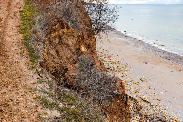 Landslide zone on Black Sea coast. Rock of sea rock shell. Zone of natural disasters during rainy season. Large masses of earth slip along slope of hill, destroy houses. Landslide - threat to life