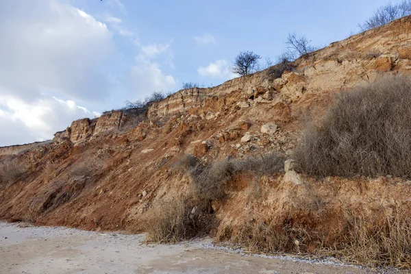 Landslide zone on Black Sea coast. Rock of sea rock shell. Zone of natural disasters during rainy season. Large masses of earth slip along slope of hill, destroy houses. Landslide - threat to lif