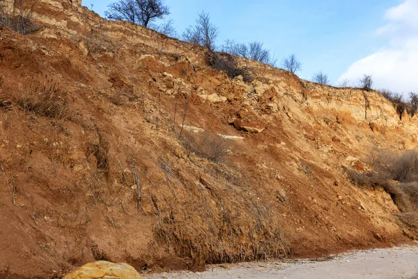 Landslide zone on Black Sea coast. Rock of sea rock shell. Zone of natural disasters during rainy season. Large masses of earth slip along slope of hill, destroy houses. Landslide - threat to lif