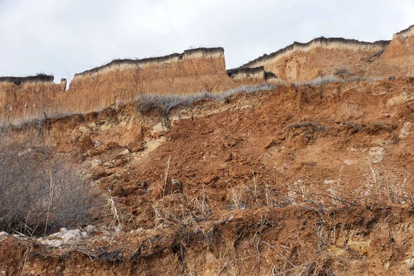 Landslide zone on Black Sea coast. Rock of sea rock shell. Zone of natural disasters during rainy season. Large masses of earth slip along slope of hill, destroy houses. Landslide - threat to lif